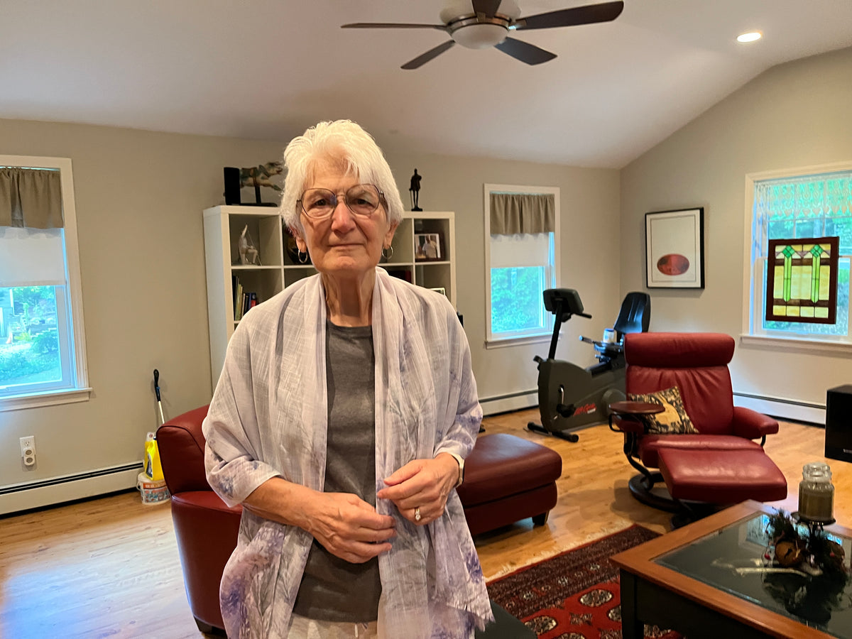 Customer wearing Sarah’s Song light scarf draped around her neck